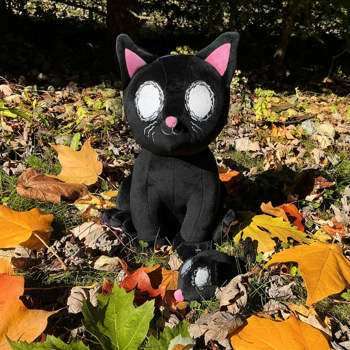 Sid the Axolotl Plush, Pumpkin the Patch Protector Plush, and Cerin the Spirit Catcher Plush all together in a field of pumpkins